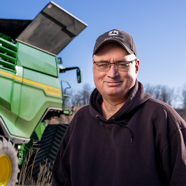 Glenn Pope standing in front of a combine